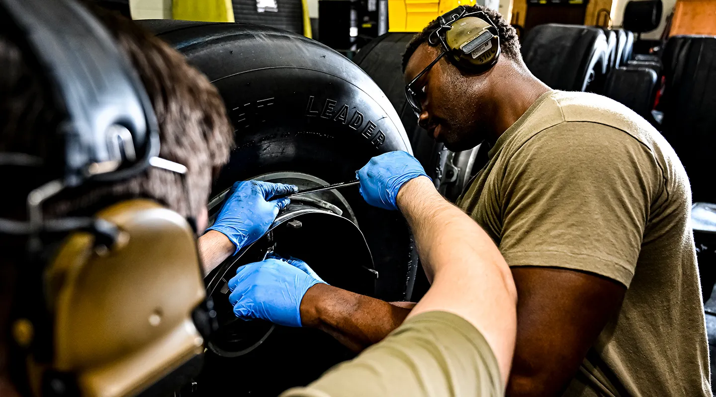 USAF soldiers repairing airlift aircraft systems.